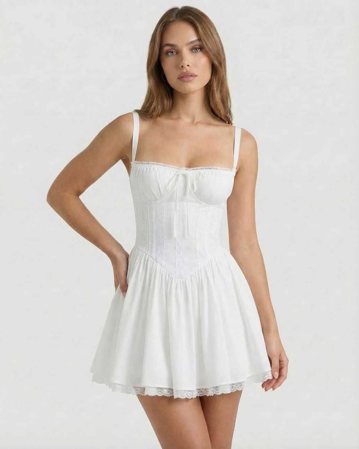 Elara Mini Dress showcases a white corset style with lace trim, offering a feminine feel by Lauven.