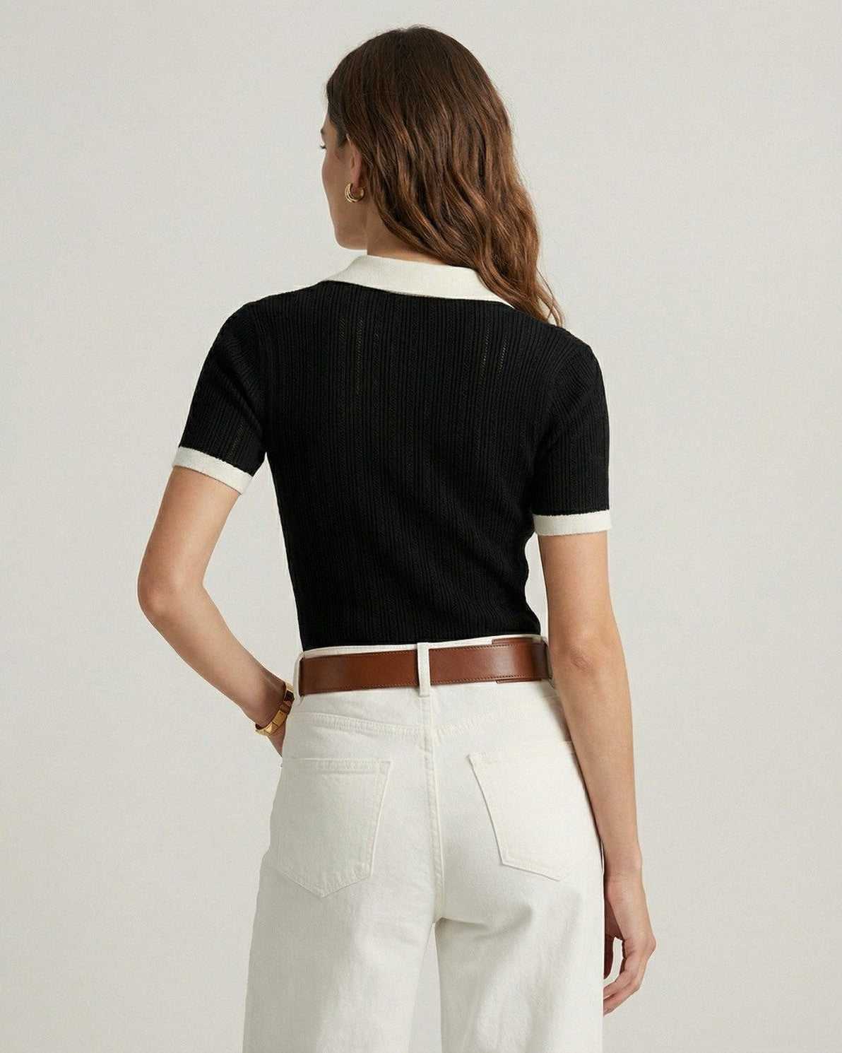 Back view of woman wearing Lauven Siena Polo Shirt in black cotton knit with contrast trim.